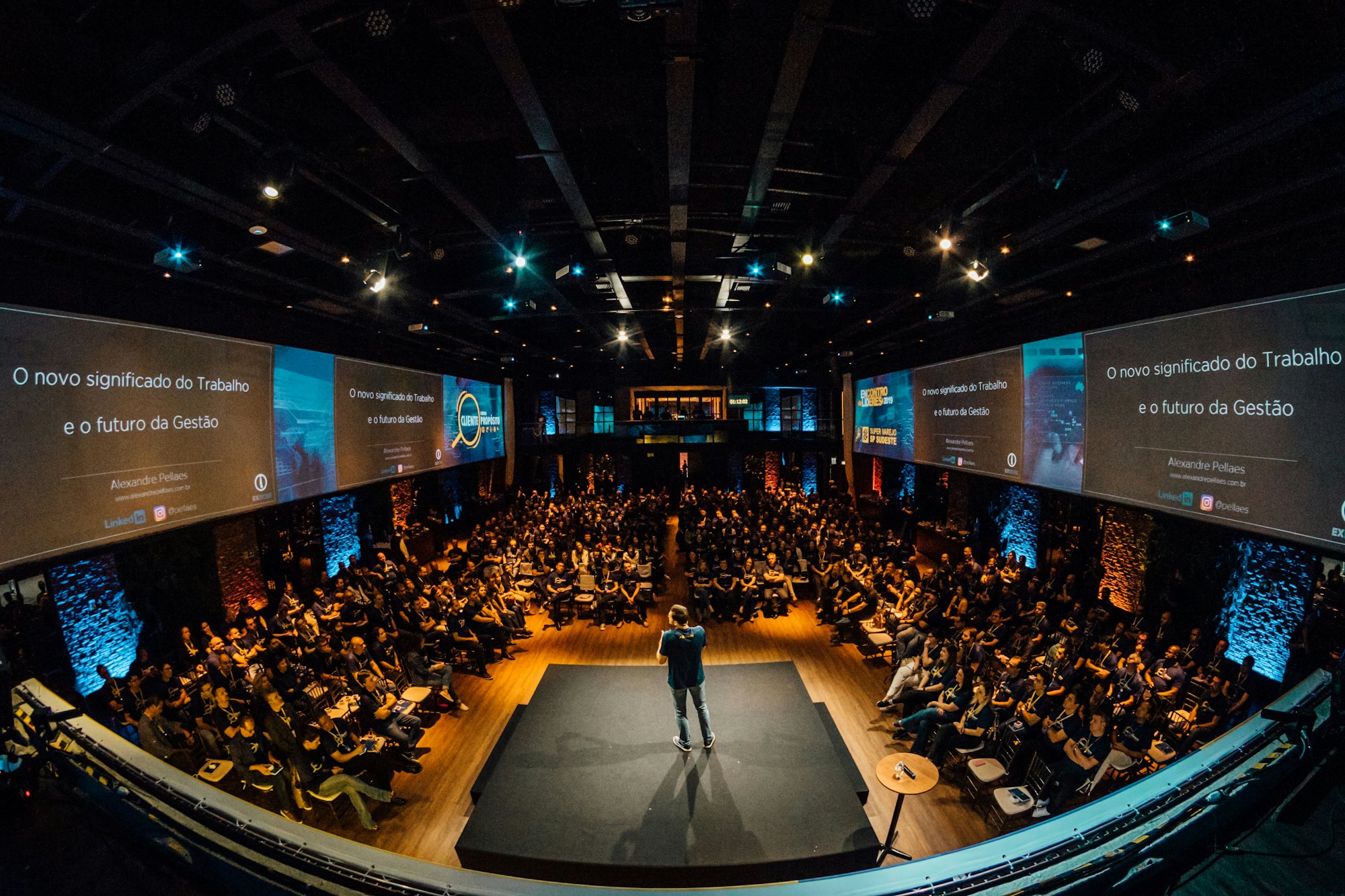 A speaker on stage at a conference